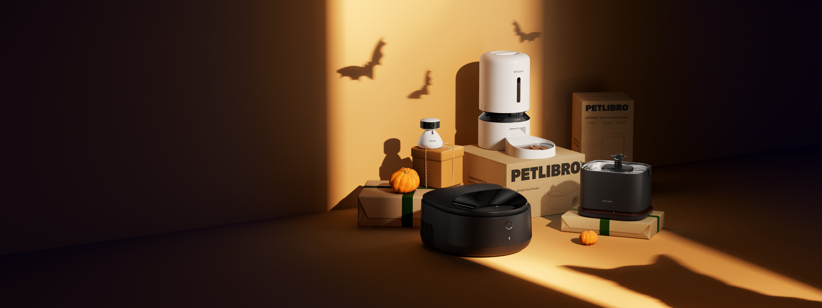 Petlibro PETLIBRO pet cat feeder, fountain and litter box display with boxes, pumpkins and bat shadows on orange backdrop