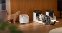 Petlibro PETLIBRO cat pet fountain and automatic feeder beside litter box, two cats drinking and eating on wood floor